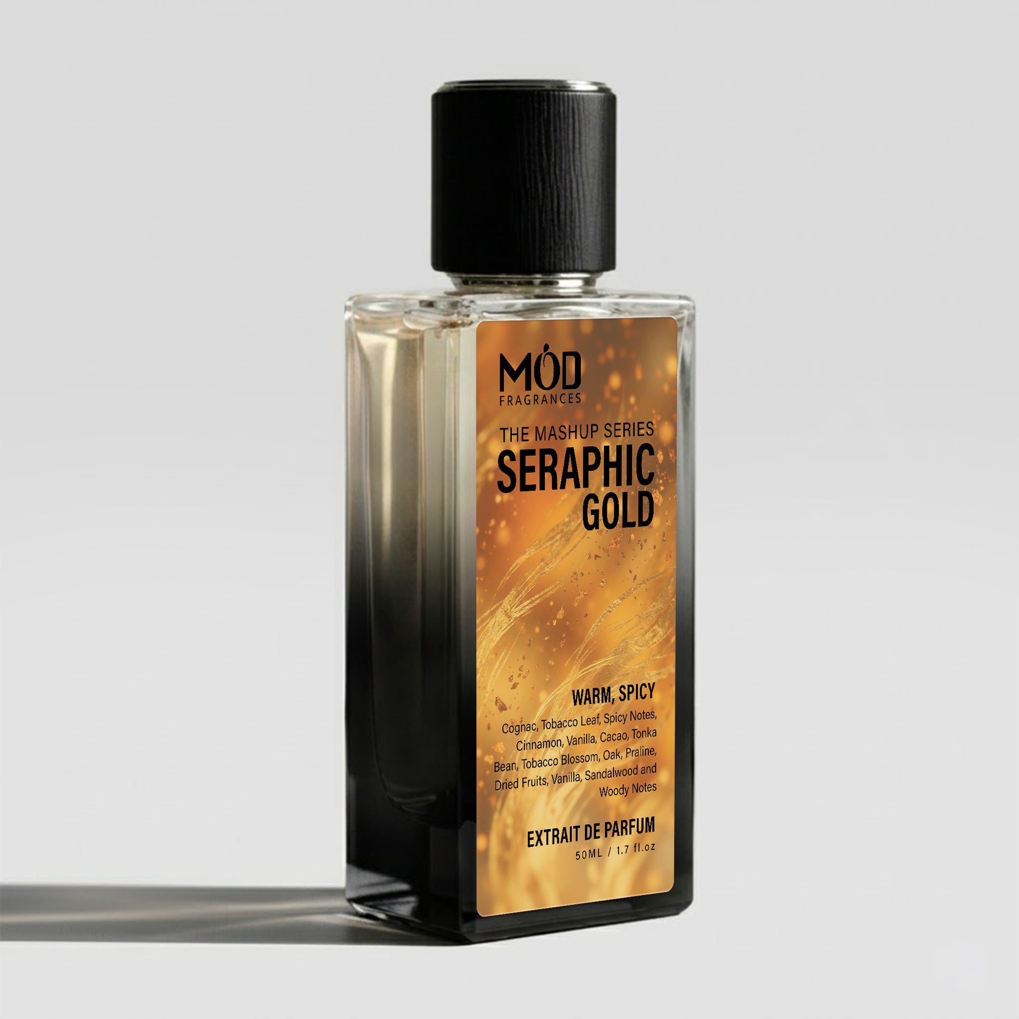 A rectangular glass perfume bottle by MOD Fragrances, labeled "Mashup series Seraphic Gold" with a small label detailing its leather, woody notes, stands on a light background.