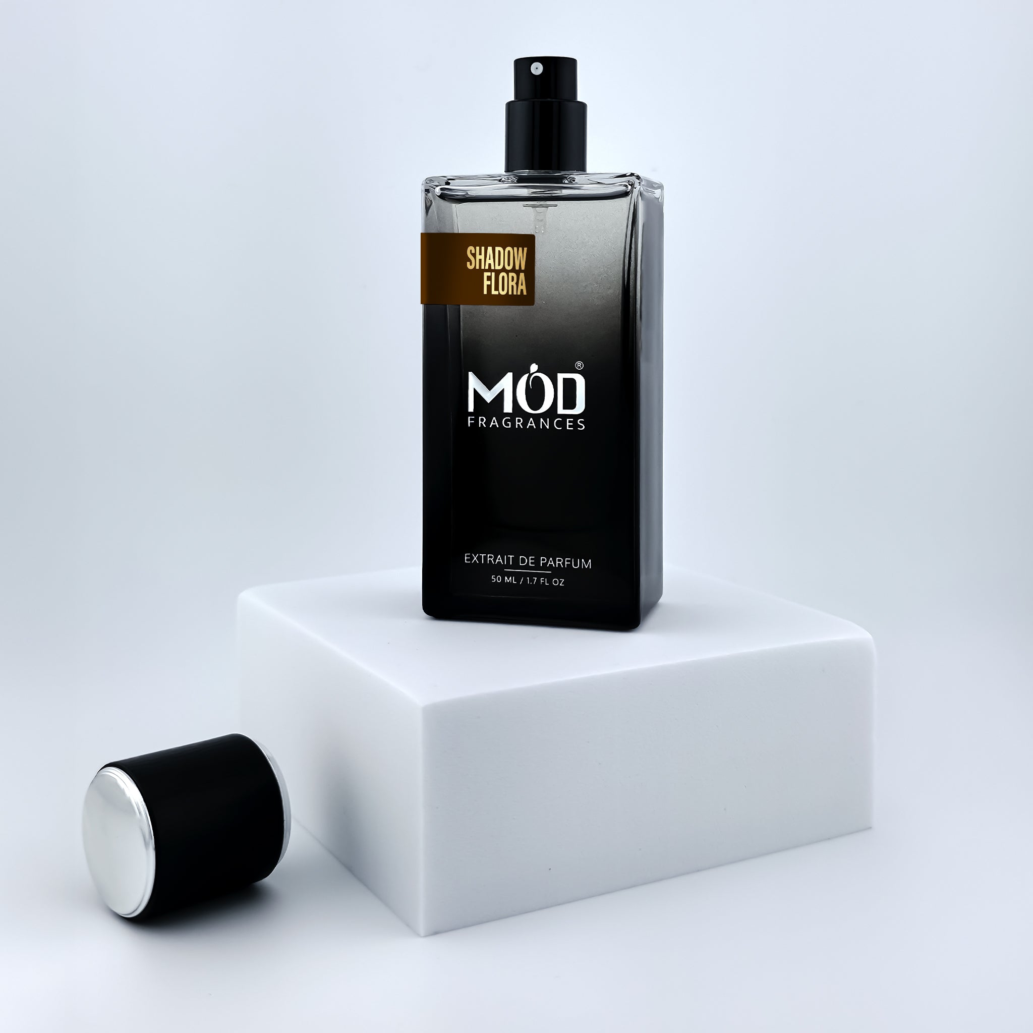 Black Möd Fragrances perfume bottle on a white platform with a light gray background
