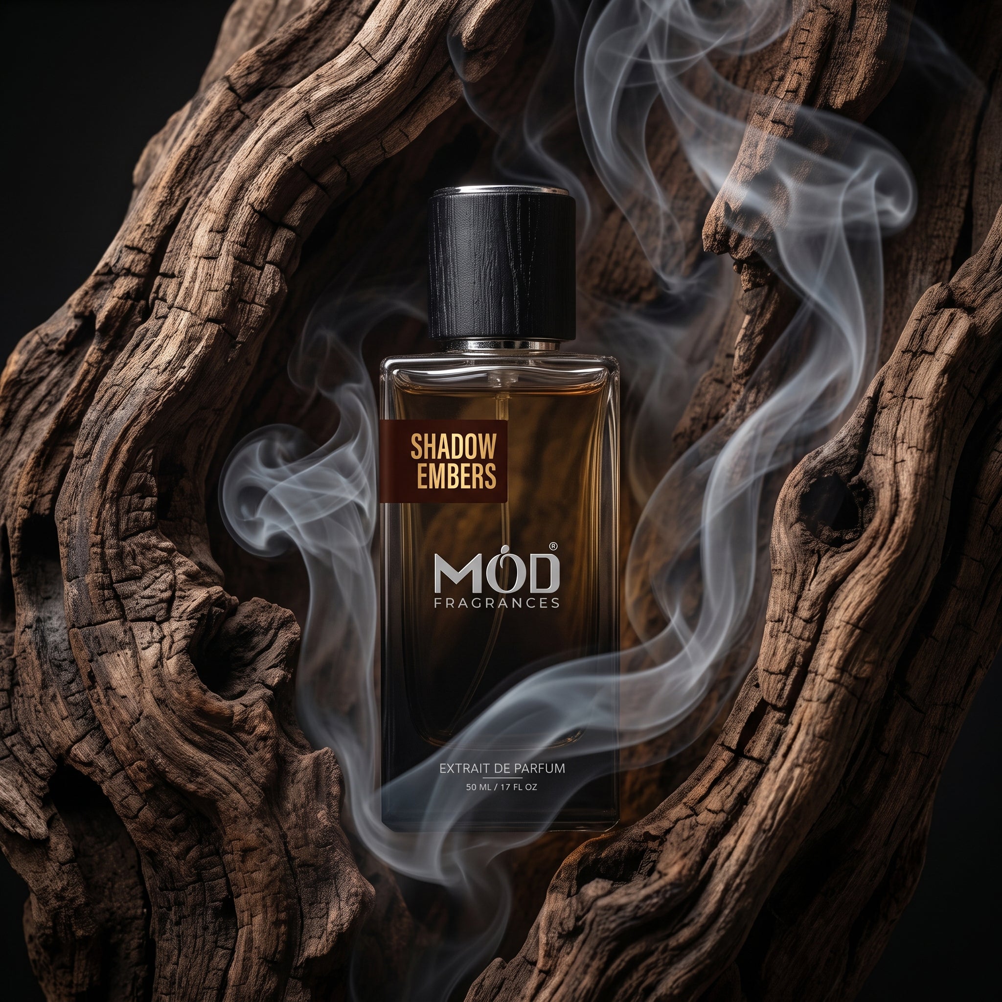 A rectangular glass perfume bottle by MOD Fragrances, labeled "Shadow Embers" is nestled inside a big oud agarwood filled with dense smoke fumes. 