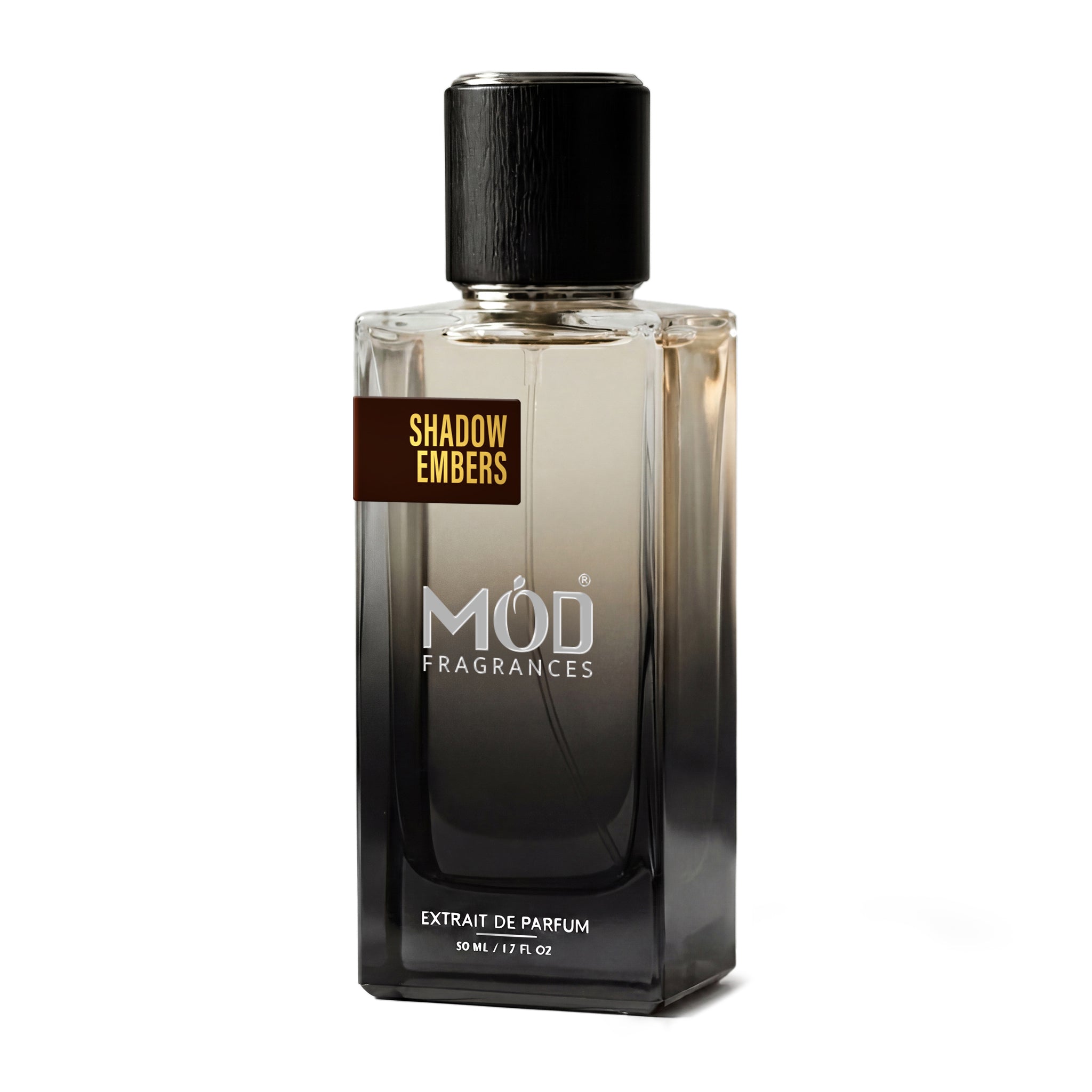 A rectangular glass perfume bottle by MOD Fragrances, labeled “Shadow Embers” stands centered against a plain white background, featuring a black cap and a gradient black-to-clear glass finish.