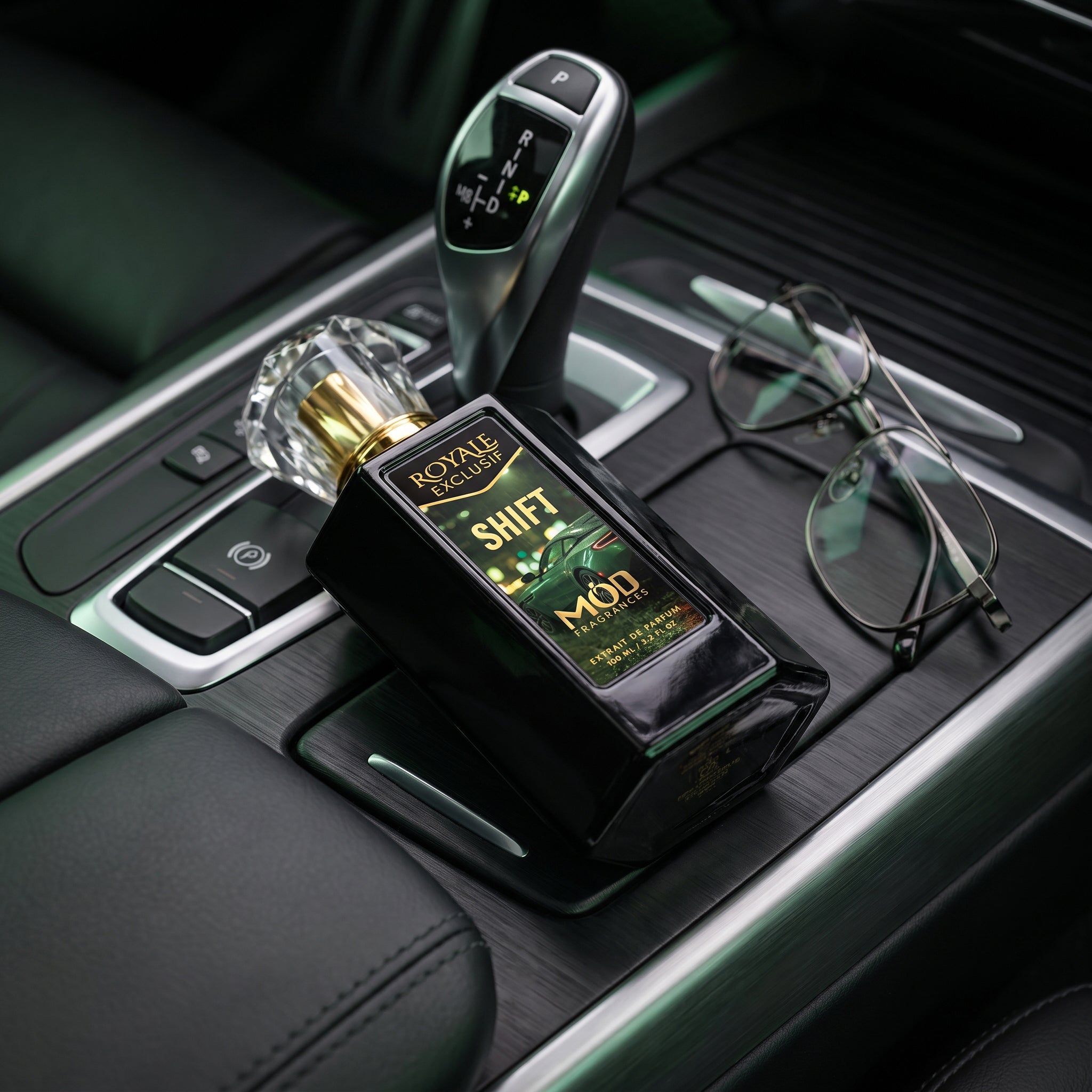 Royale Exclusif Shift by MOD fragrances, 100ml luxury black laid on exotic luxury car interior console, beside glasses and gear shifter