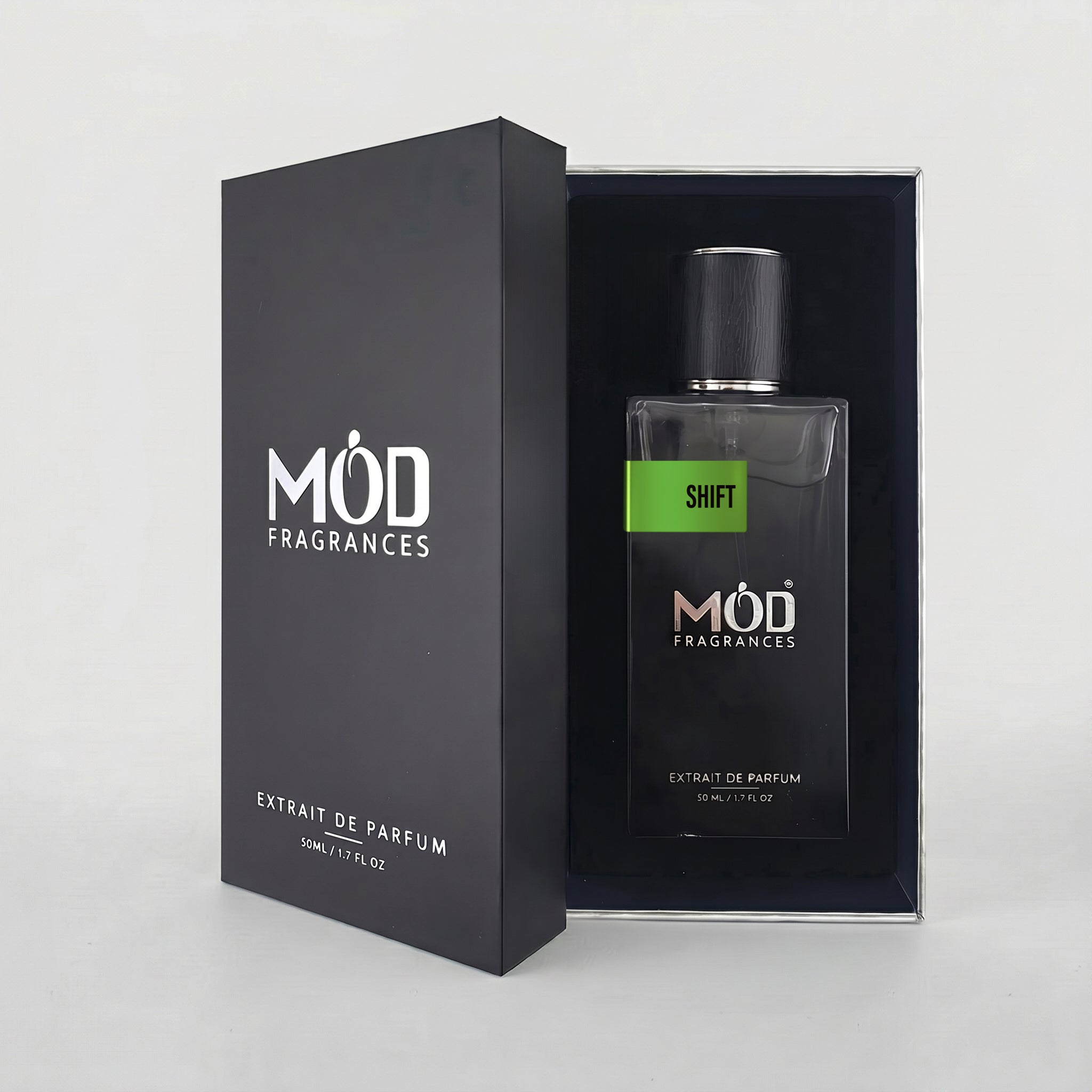 An open black perfume box reveals a rectangular glass bottle labeled “Shift” by MOD Fragrances, resting securely in a black-lined presentation case.