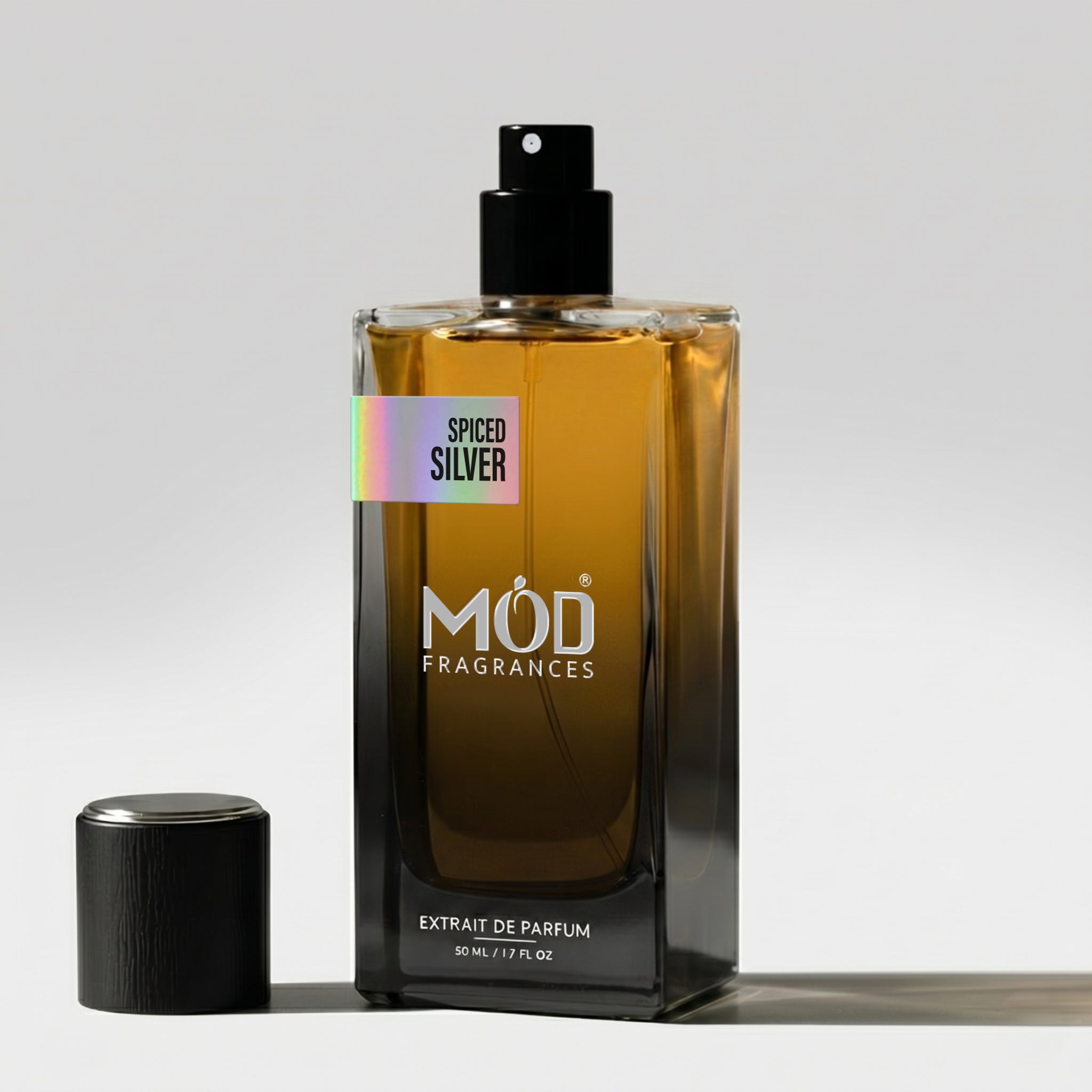 Perfume bottle labeled 'Spiced Silver' by MOD Fragrances on a light gray background