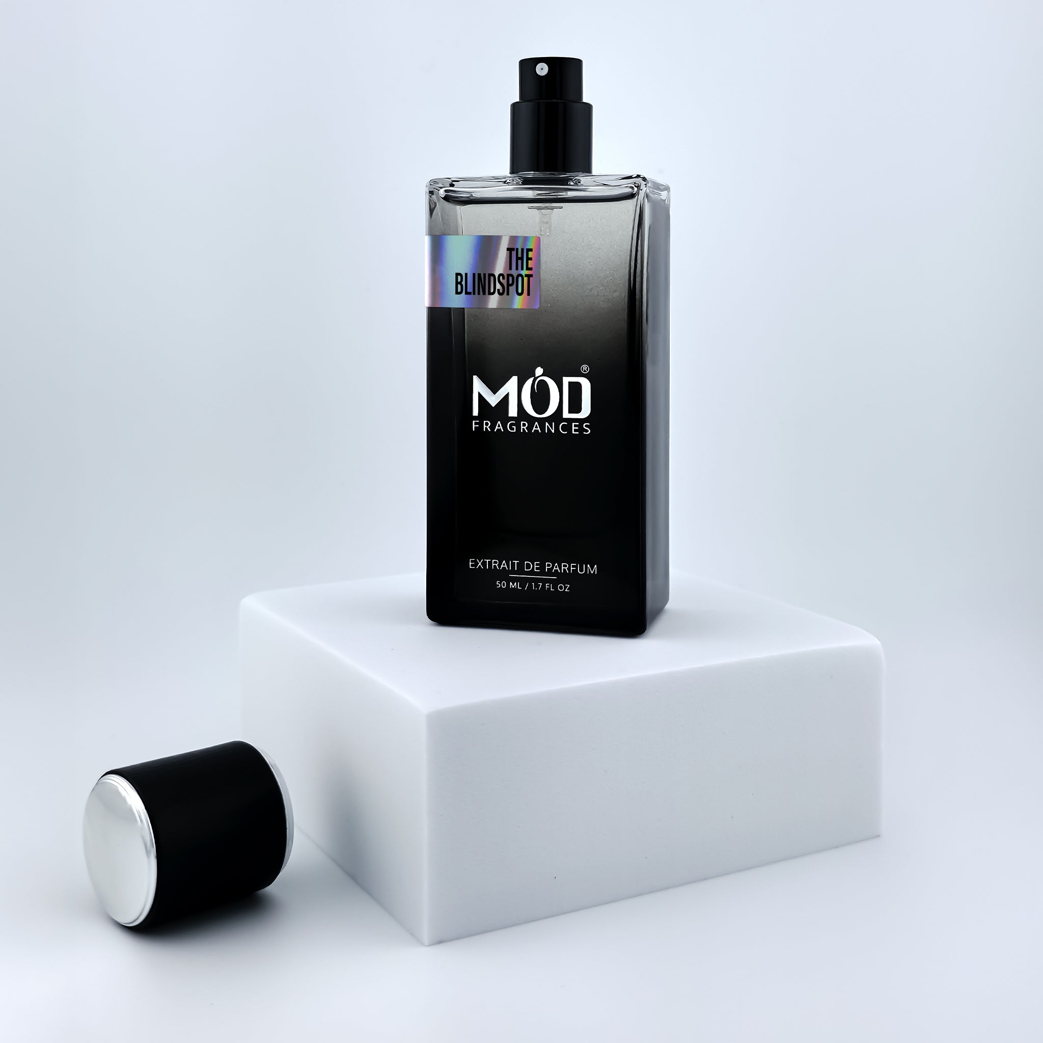 Black perfume bottle with 'MOD Fragrances' branding on a white platform.