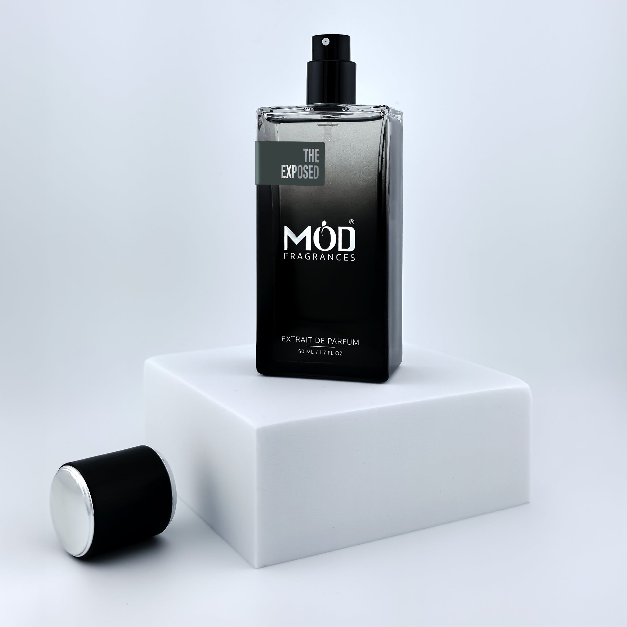Black perfume bottle with 'MOD Fragrances' branding on a white platform.