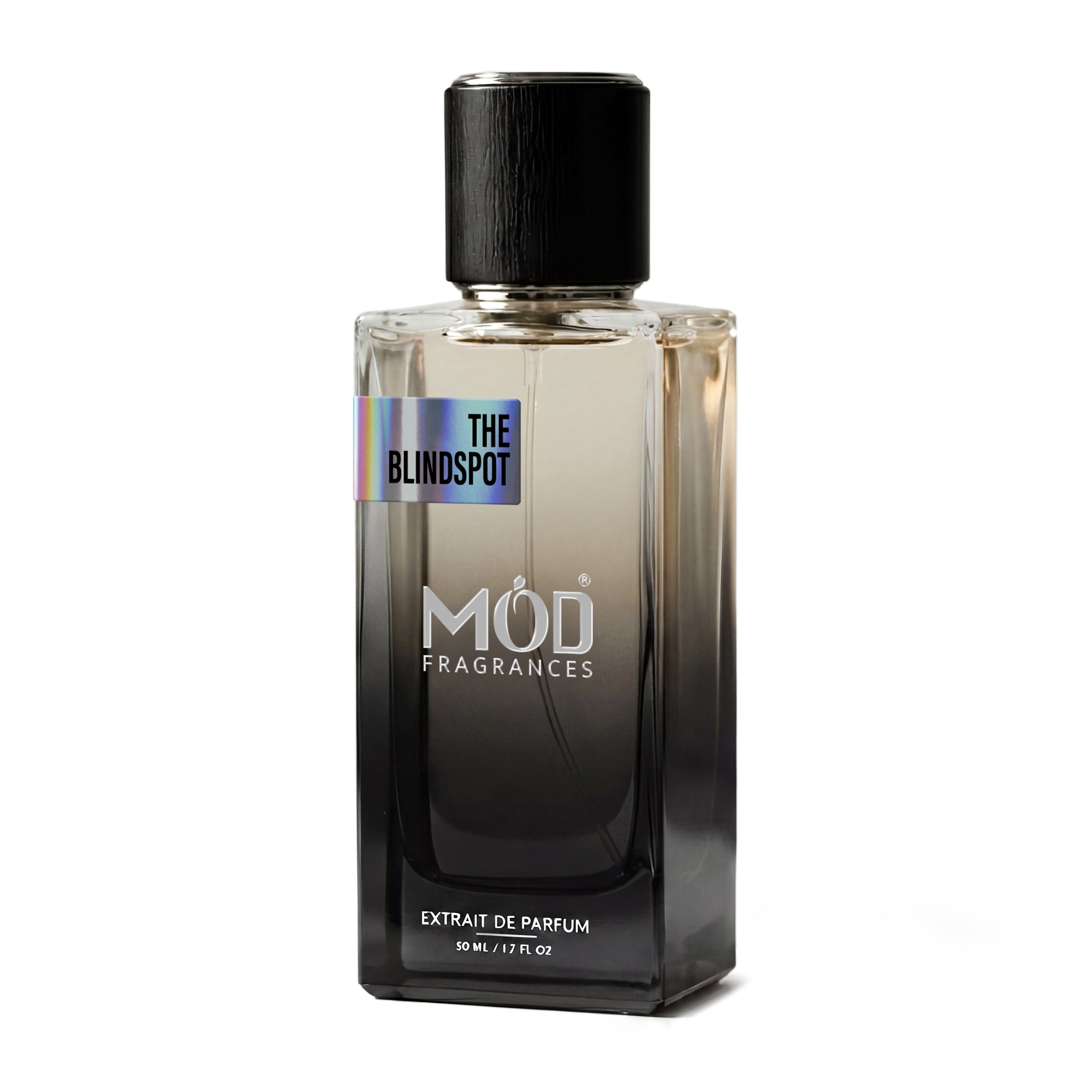 A rectangular glass perfume bottle by MOD Fragrances, labeled "The Blindspot," stands centered against a plain white background, featuring a black cap and a gradient black-to-clear glass finish.