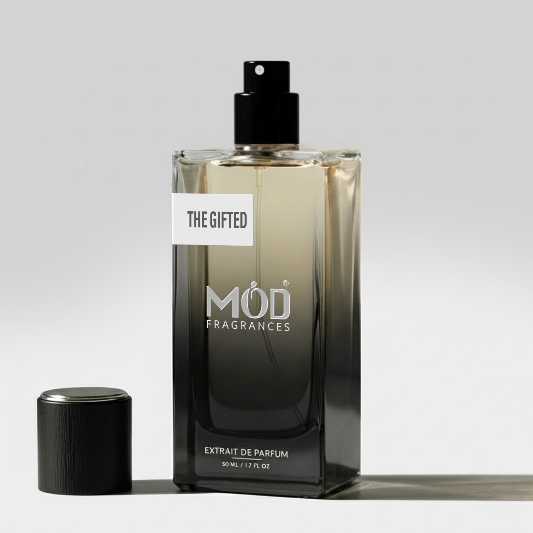 Perfume bottle labeled 'The Gifted' by MOD Fragrances on a light gray background