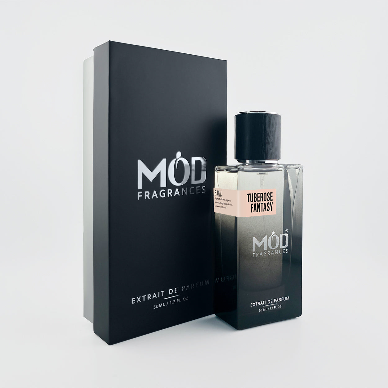 A bottle of Mod Fragrances Tuberose Fantasy Extrait de Parfum next to its black presentation box, set against a clean light gray background.