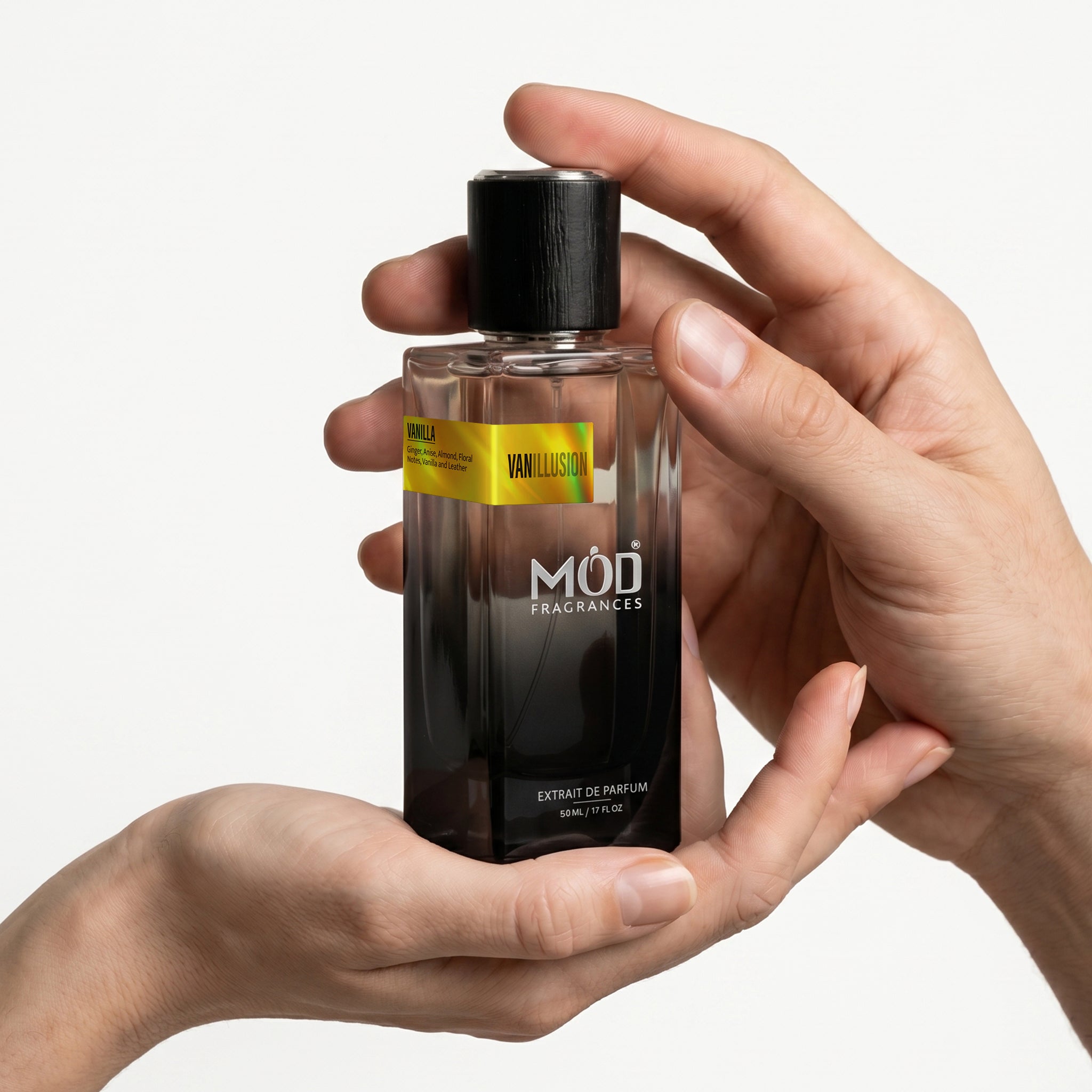 Hand holding a MOD Fragrances perfume bottle with a white background