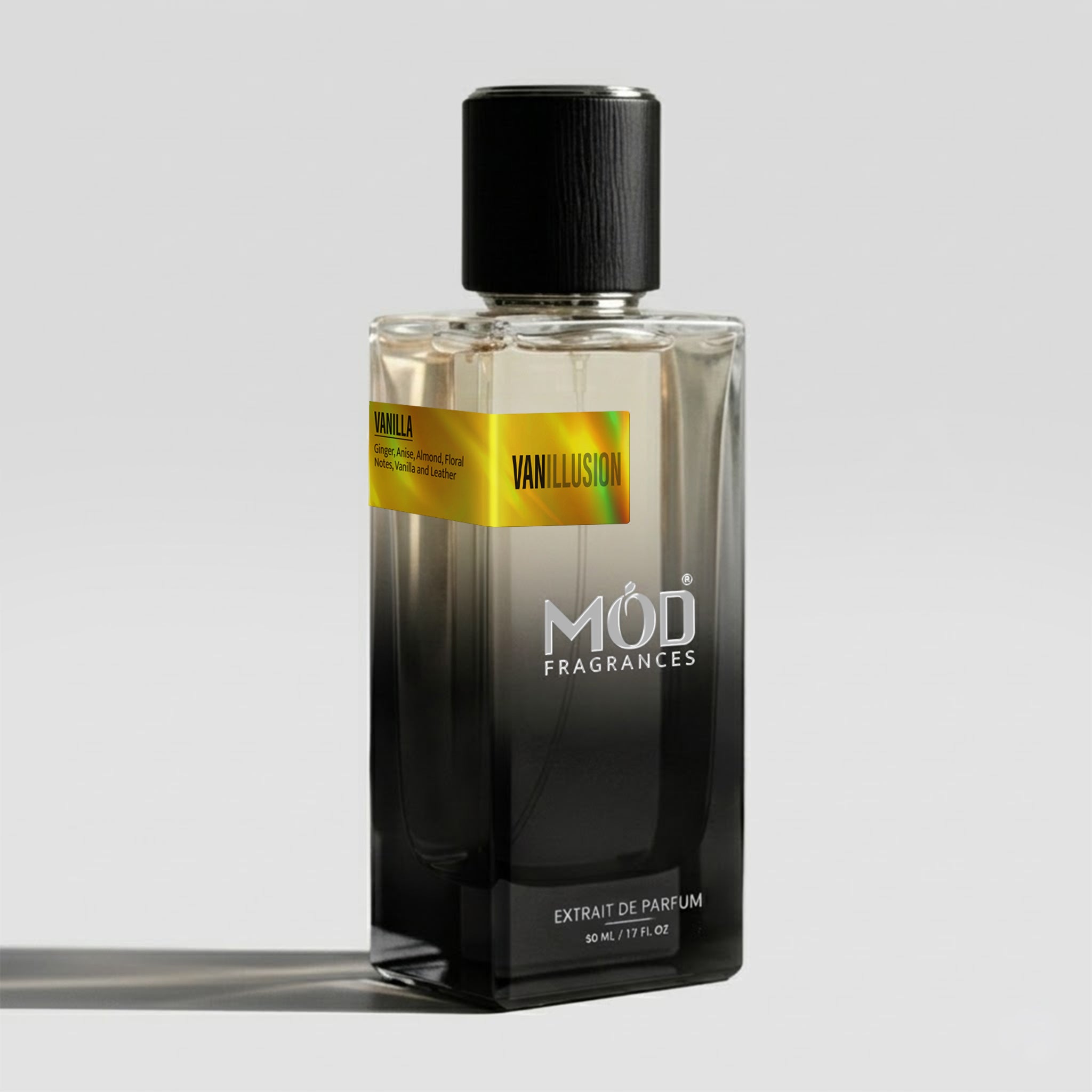 A bottle of Mod Fragrances Vanillion Extrait de Parfum, featuring a black cap and a faceted glass bottle that transitions from clear at the top to dark smoky black at the bottom. A gold label on the bottle reads 'VANILLA' and 'VANILLION'.