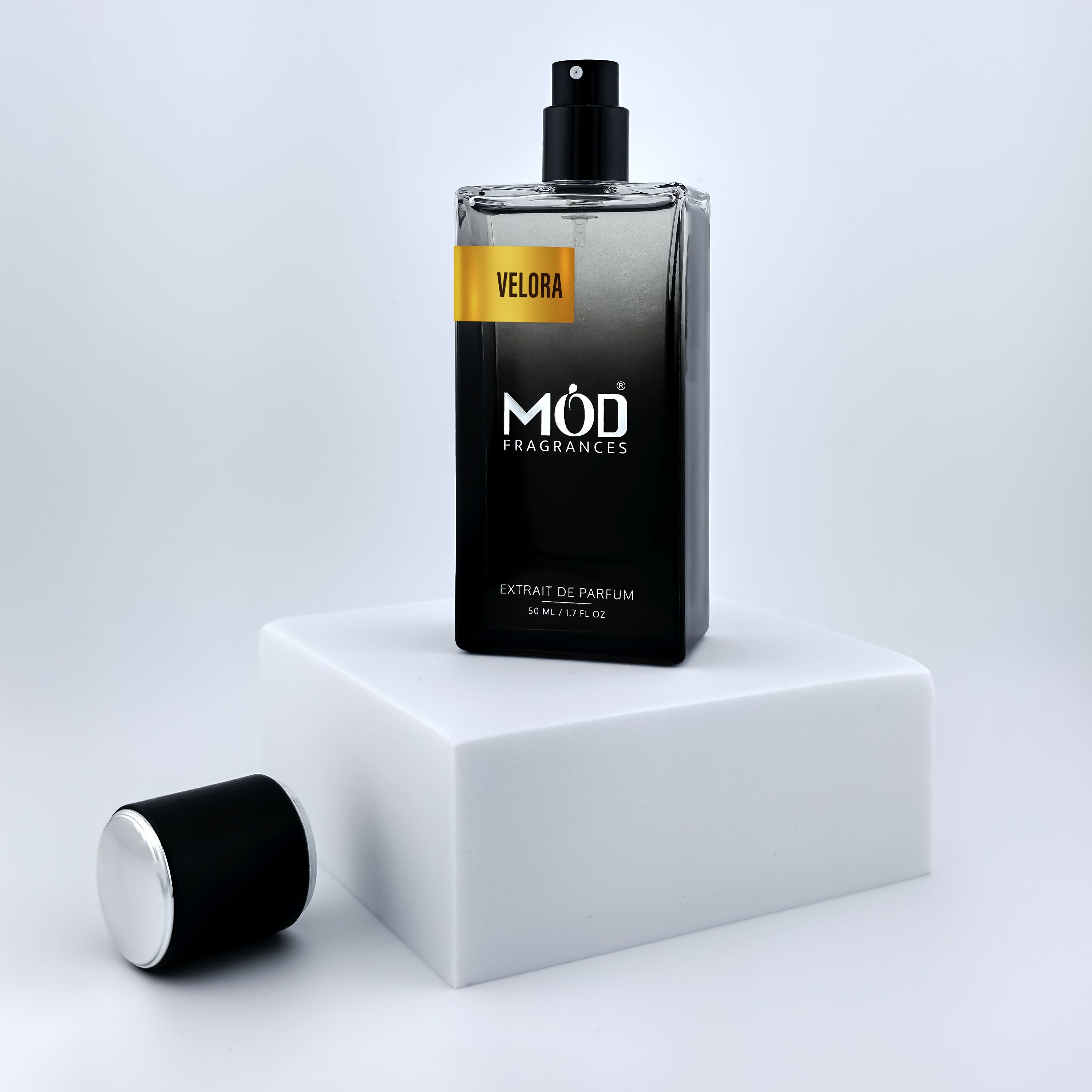 Libre Perfume Dupe Black perfume bottle with 'Möd Fragrances' branding on a white platform.