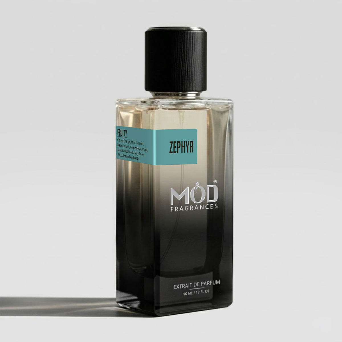 A rectangular glass perfume bottle by MOD Fragrances, labeled “Zephyr” with a small label detailing its notes, stands on a light background.