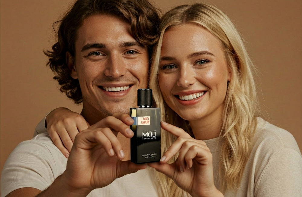 A happy couple holding a Mod Fragrances perfume bottle. 